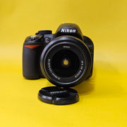b) Nikon D3100 DSLR Camera with 18-55mm G VR Lens | 14.2MP | Full HD Video | Beginner Friendly DSLR | Budget Photography Camera | Code AB06 📸