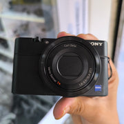 a) Sony DSC-RX100 Cyber-shot | Premium Compact Point & Shoot Camera | 20.2MP Cyber-shot Camera with Zeiss Lens | SK154