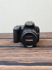 a) Canon EOS 200D DSLR Camera with 18-55mm STM Lens | 24.2MP APS-C | Dual Pixel AF | Full HD Video | WiFi & Bluetooth | Lightweight DSLR