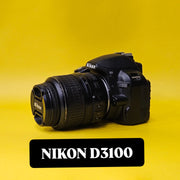 b) Nikon D3100 DSLR Camera with 18-55mm G VR Lens | 14.2MP | Full HD Video | Beginner Friendly DSLR | Budget Photography Camera | Code AB06 📸
