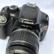 a) Canon EOS Rebel T2i DSLR Camera with 18-55mm Lens | 18MP | Full HD Video | Perfect for Beginners & Creators SK1039