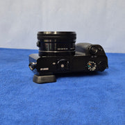 c) Sony Alpha A6000 + 16-50mm OSS Lens – Perfect for Photography & Video