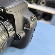 a) Canon EOS 1200D DSLR Camera with 18-55mm IS II Lens | 18MP | Full HD Video | Beginner Friendly | AB02