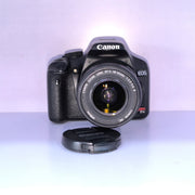 b) Canon EOS Rebel T1i DSLR Camera with 18-55mm Lens | 15.1MP | Full HD Video | Compact & Beginner Friendly | SK1032