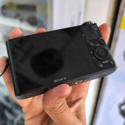 a) Sony DSC-RX100 Cyber-shot | Premium Compact Point & Shoot Camera | 20.2MP Cyber-shot Camera with Zeiss Lens | SK154