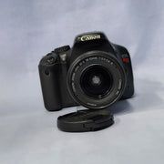 a) Canon EOS Rebel T2i DSLR Camera with 18-55mm Lens | 18MP | Full HD Video | Perfect for Beginners & Creators SK1039