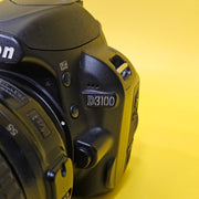 b) Nikon D3100 DSLR Camera with 18-55mm G VR Lens | 14.2MP | Full HD Video | Beginner Friendly DSLR | Budget Photography Camera | Code AB06 📸