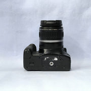a) Canon EOS Rebel T2i DSLR Camera with 18-55mm Lens | 18MP | Full HD Video | Perfect for Beginners & Creators SK1039