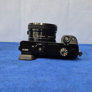 c) Sony Alpha A6000 + 16-50mm OSS Lens – Perfect for Photography & Video