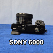 c) Sony Alpha A6000 + 16-50mm OSS Lens – Perfect for Photography & Video