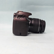 a) Canon EOS 1100D DSLR Camera with 18-55mm IS II Lens | 12.2MP APS-C | Beginner Friendly Camera | Lightweight DSLR | (Code AB01)