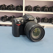 b) Nikon D90 DSLR Camera with 18-105mm VR Lens | 12.3MP | HD Video | Reliable Nikon DX Camera | SK252
