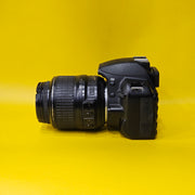 b) Nikon D3100 DSLR Camera with 18-55mm G VR Lens | 14.2MP | Full HD Video | Beginner Friendly DSLR | Budget Photography Camera | Code AB06 📸