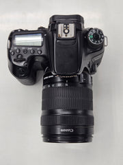 a) Canon EOS 70D DSLR Camera with 18-135mm IS Lens | 20.2MP APS-C Sensor | Dual Pixel Autofocus | Full HD Video | Versatile Zoom Kit | SK1053