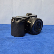 c) Sony Alpha A6000 + 16-50mm OSS Lens – Perfect for Photography & Video