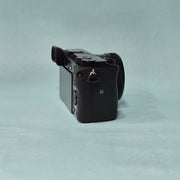 c) Sony A6100 Mirrorless Camera with Kit Lens – Excellent Condition