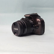 a) Canon EOS 1100D DSLR Camera with 18-55mm IS II Lens | 12.2MP APS-C | Beginner Friendly Camera | Lightweight DSLR | (Code AB01)
