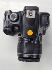 a) Canon EOS 1300D DSLR Camera with 18-55mm Lens | 18MP APS-C | Full HD Video | WiFi | Beginner Friendly DSLR