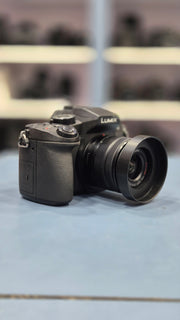 c) Panasonic Lumix G85 with 14-42mm Lens – 16MP 4K Mirrorless Camera | Weather-Sealed | 5-Axis Stabilization