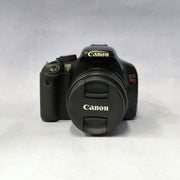 a) Canon EOS Rebel T2i DSLR Camera with 18-55mm Lens | 18MP | Full HD Video | Perfect for Beginners & Creators SK1039