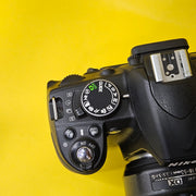 b) Nikon D3100 DSLR Camera with 18-55mm G VR Lens | 14.2MP | Full HD Video | Beginner Friendly DSLR | Budget Photography Camera | Code AB06 📸