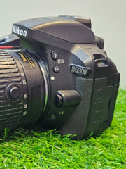a) Nikon D5300 DSLR Camera with 18-55mm f/3.5-5.6 VR Lens | 24.2MP APS-C Sensor | Full HD Video | WiFi & GPS | Vari-Angle Screen | Beginner Friendly Photography Camera 📸🔥