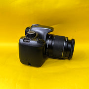 a) Canon EOS 1100D with 18-55mm f/3.5-5.6 IS II Lens | Beginner DSLR Camera for Photography & HD Video Shooting | SK196