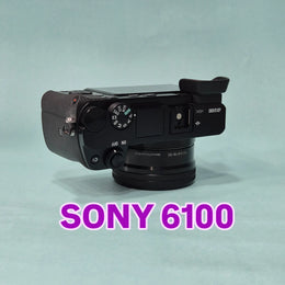 c) Sony A6100 Mirrorless Camera with Kit Lens – Excellent Condition