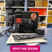 a) Sony DSC-RX100 Cyber-shot | Premium Compact Point & Shoot Camera | 20.2MP Cyber-shot Camera with Zeiss Lens | SK154