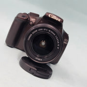 a) Canon EOS 1100D DSLR Camera with 18-55mm IS II Lens | 12.2MP APS-C | Beginner Friendly Camera | Lightweight DSLR | (Code AB01)