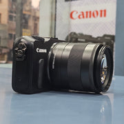 a) Canon EOS M Mirrorless Camera with 18-55mm Lens | Compact APS-C Camera (Code: AB36)