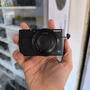 a) Sony DSC-RX100 Cyber-shot | Premium Compact Point & Shoot Camera | 20.2MP Cyber-shot Camera with Zeiss Lens | SK154