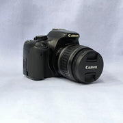 a) Canon EOS Rebel T2i DSLR Camera with 18-55mm Lens | 18MP | Full HD Video | Perfect for Beginners & Creators SK1039
