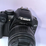 b) Canon EOS Rebel T1i DSLR Camera with 18-55mm Lens | 15.1MP | Full HD Video | Compact & Beginner Friendly | SK1032