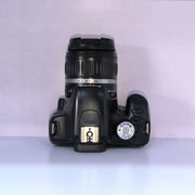 b) Canon EOS Rebel T1i DSLR Camera with 18-55mm Lens | 15.1MP | Full HD Video | Compact & Beginner Friendly | SK1032