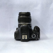 a) Canon EOS Rebel T2i DSLR Camera with 18-55mm Lens | 18MP | Full HD Video | Perfect for Beginners & Creators SK1039