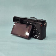 c) Sony A6100 Mirrorless Camera with Kit Lens – Excellent Condition
