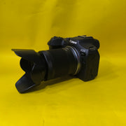 a) Canon EOS R7 with RF-S 18-150mm F3.5-6.3 IS STM Lens | 32.5MP APS-C Mirrorless Camera for Wildlife, Sports & Hybrid Creators | SK148