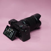 b) Sony A6400 Mirrorless Camera with 18-135mm f/3.5-5.6 OSS Lens | 24.2MP APS-C | 4K Video | Fast AF | SK522