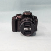 a) Canon EOS 1100D DSLR Camera with 18-55mm IS II Lens | 12.2MP APS-C | Beginner Friendly Camera | Lightweight DSLR | (Code AB01)