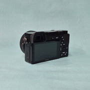 c) Sony A6100 Mirrorless Camera with Kit Lens – Excellent Condition