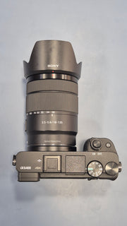 c) Sony Alpha A6400 + 18-135mm Zoom Lens (Excellent Condition)