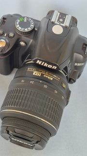 c) Nikon D3000 with 18-55mm Lens – 10.2MP DSLR Camera | Beginner Friendly | Sharp Image Quality