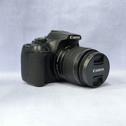 b) Canon EOS 1500D DSLR Camera with 18-55mm IS II Lens | 24.1MP | Full HD Video | WiFi | AB04