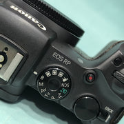 b) Canon EOS RP Full-Frame Mirrorless Camera Body | 26MP | 4K Video | Dual Pixel AF | Compact & Lightweight | SK1021