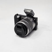 b) Sony NEX-5 with 18-55mm OSS Lens | Compact Mirrorless Camera Kit | SK503